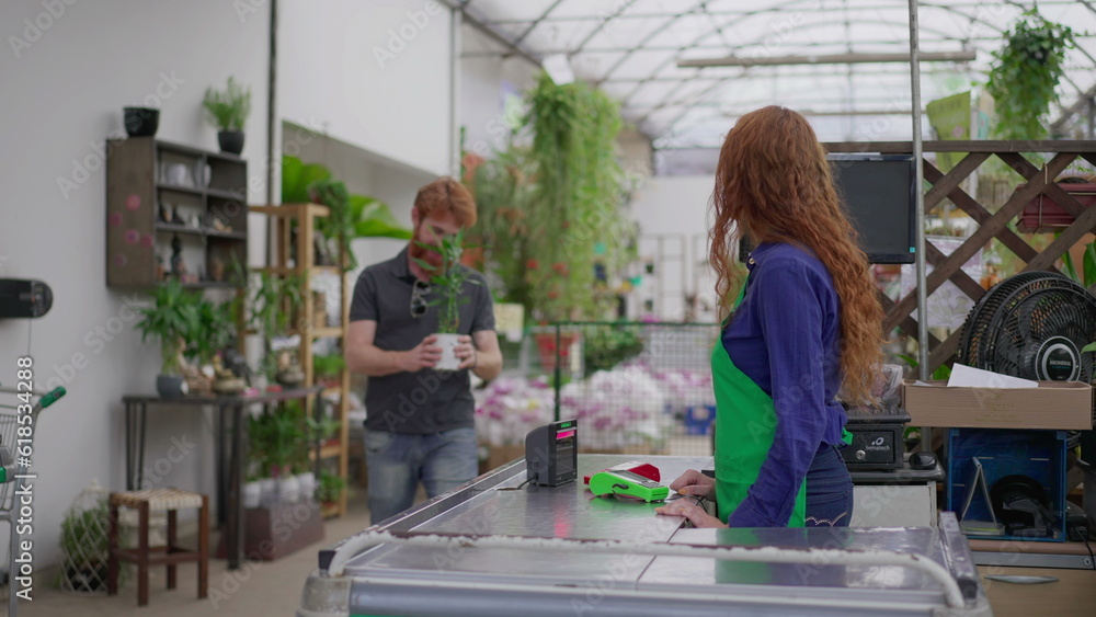 Customer Making Contactless Phone Payment for Plant at Horticulture Shop Checkout Customer Making Contactless Phone Payment for Plant at Horticulture Shop Checkout