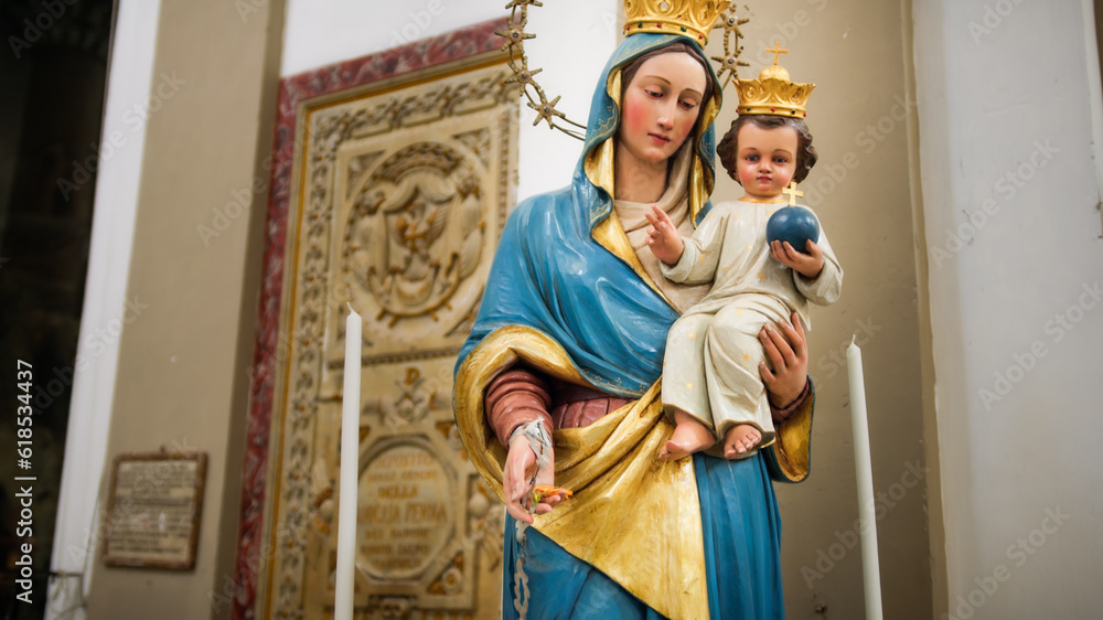 The Madonna with baby Jesus in her arms statue of a church