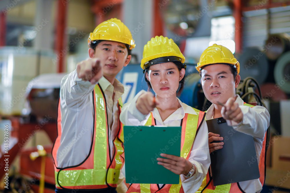 Header mentor and young employees trainee stand for operating machine looking see through camera monitor and point finger with angry serious mood. foreman team young engineer angry serious mood Header mentor and young employees trainee stand for operating machine looking see through camera monitor and point finger with angry serious mood. foreman team young engineer angry serious mood