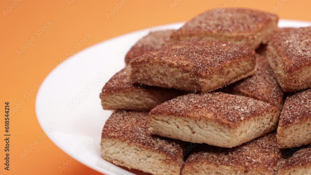 Fresh Cookies Rotating. Cookies With Sugar. Sugar Biscuits In White Plate. Food Concept On Orange Background. 4k, 60 FPS, ProRes Fresh Cookies Rotating. Cookies With Sugar. Sugar Biscuits In White Plate. Food Concept On Orange Background. 4k, 60 FPS, ProRes