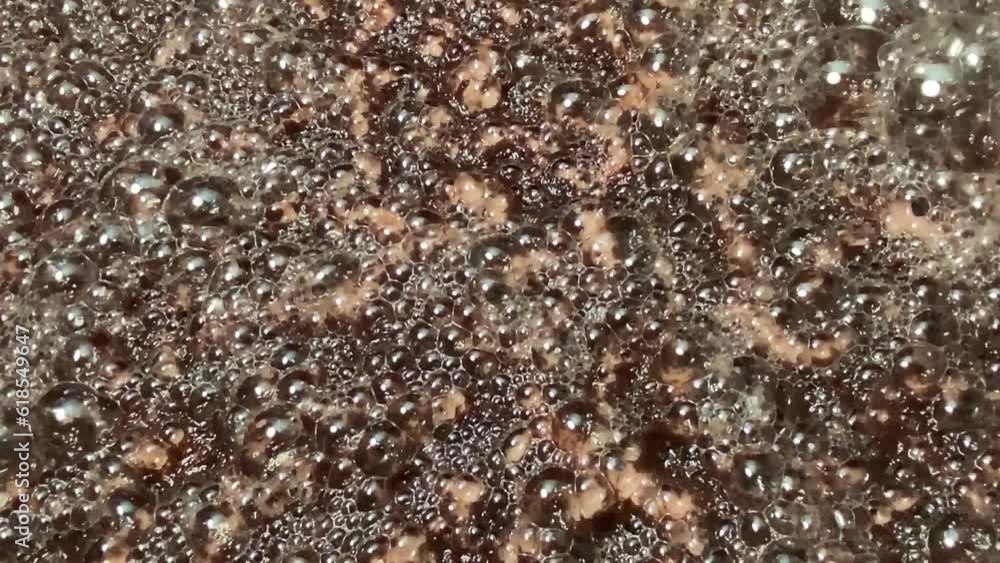 Bubbles formed on the surface of wine must caused by the residual carbon dioxide produced during the fermentation activity of yeast. Textures, Close up Bubbles formed on the surface of wine must caused by the residual carbon dioxide produced during the fermentation activity of yeast. Textures, Close up