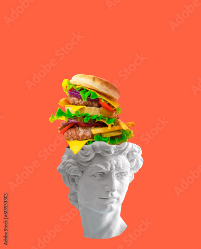 Creative art collage of David's head with huge burger flying out of his head on orange background. Fast food and overeating concept. photo