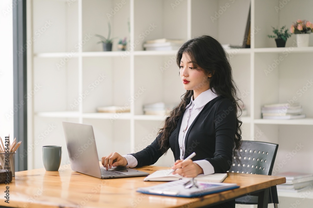 A portrait of a smiling, young, beautiful, professional, and confident millennial caucasian businesswoman using a digital tablet to analyze sales data at a modern office. A portrait of a smiling, young, beautiful, professional, and confident millennial caucasian businesswoman using a digital tablet to analyze sales data at a modern office.
