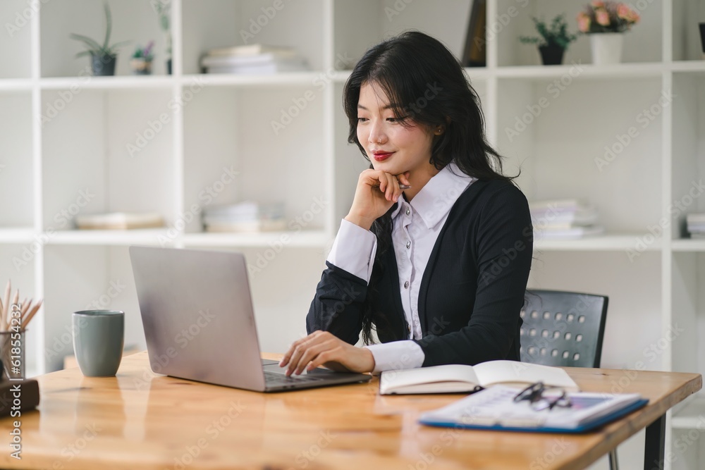 A portrait of a smiling, young, beautiful, professional, and confident millennial caucasian businesswoman using a digital tablet to analyze sales data at a modern office. A portrait of a smiling, young, beautiful, professional, and confident millennial caucasian businesswoman using a digital tablet to analyze sales data at a modern office.