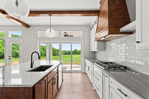 brand new white kitchen counter tops and raw stained wood cabinets and kitchen island. 