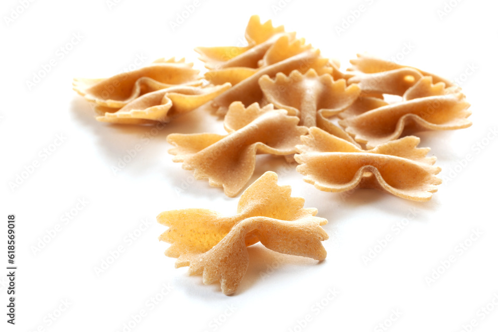 wholemeal raw pasta on a white background, top view wholemeal raw pasta on a white background, top view