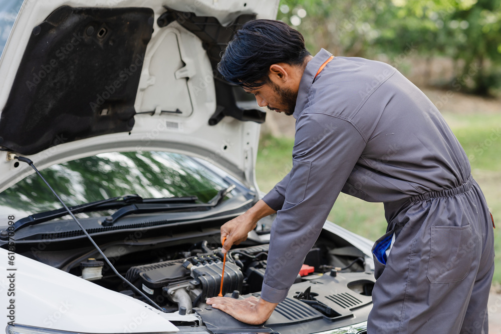 Car mechanic working in auto repair service.