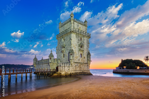 Belem Tower or Tower of St Vincent - famous tourist landmark of Lisboa and tourism attraction - on the bank of the Tagus River Tejo in evening dusk after sunset with dramatic sky. Lisbon, Portugal