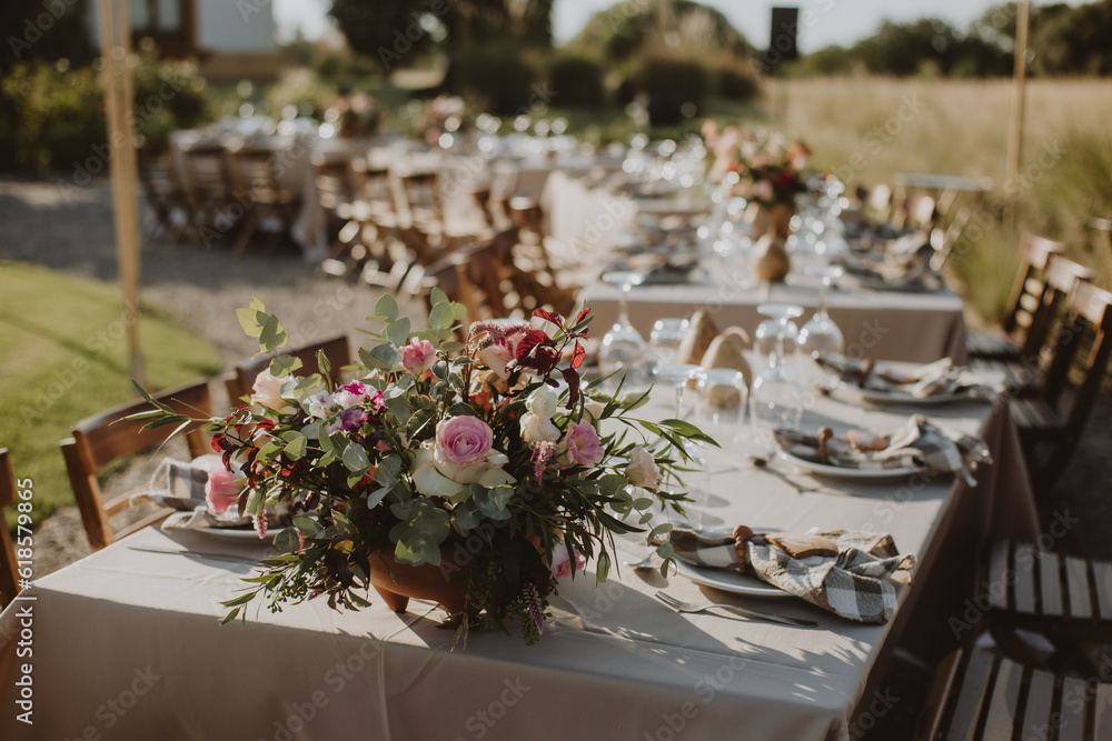 Fototapeta premium outdoor wedding decoration. Table setting with flowers.