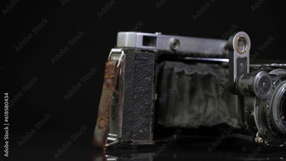 Old non-working photo camera in the open state. Dolly shot Old non-working photo camera in the open state. Dolly shot