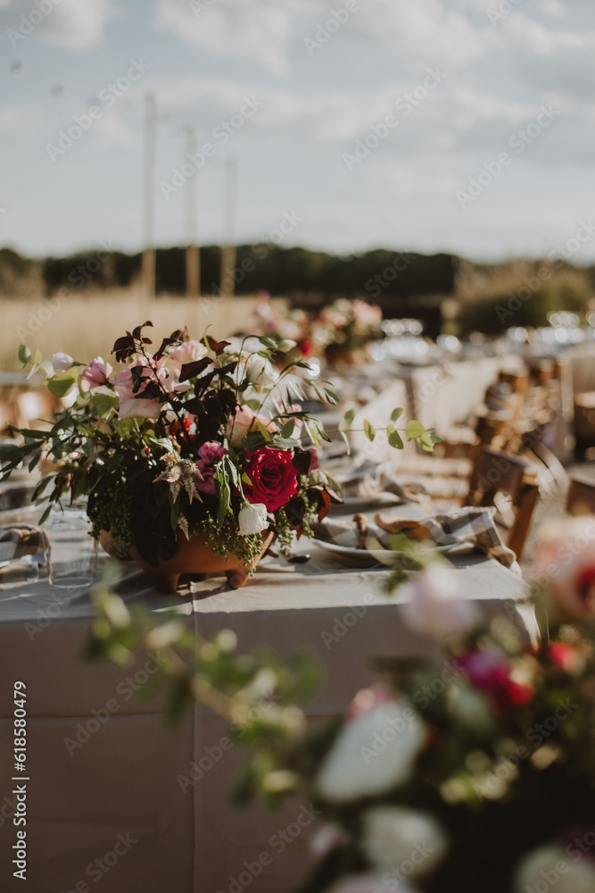 outdoor wedding decoration. Table setting with flowers.