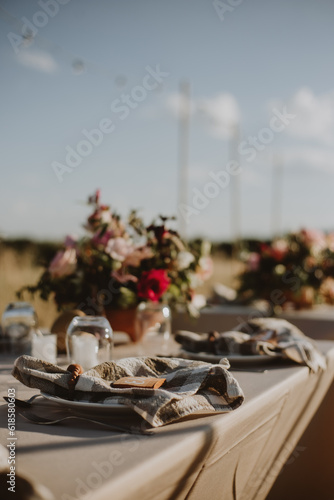 Fototapeta Naklejka Na Ścianę i Meble -  outdoor wedding decoration. Table setting with flowers.