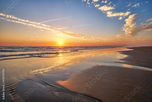 Atlantic ocean sunset with surging waves at Fonte da Telha beach  Costa da Caparica  Portugal