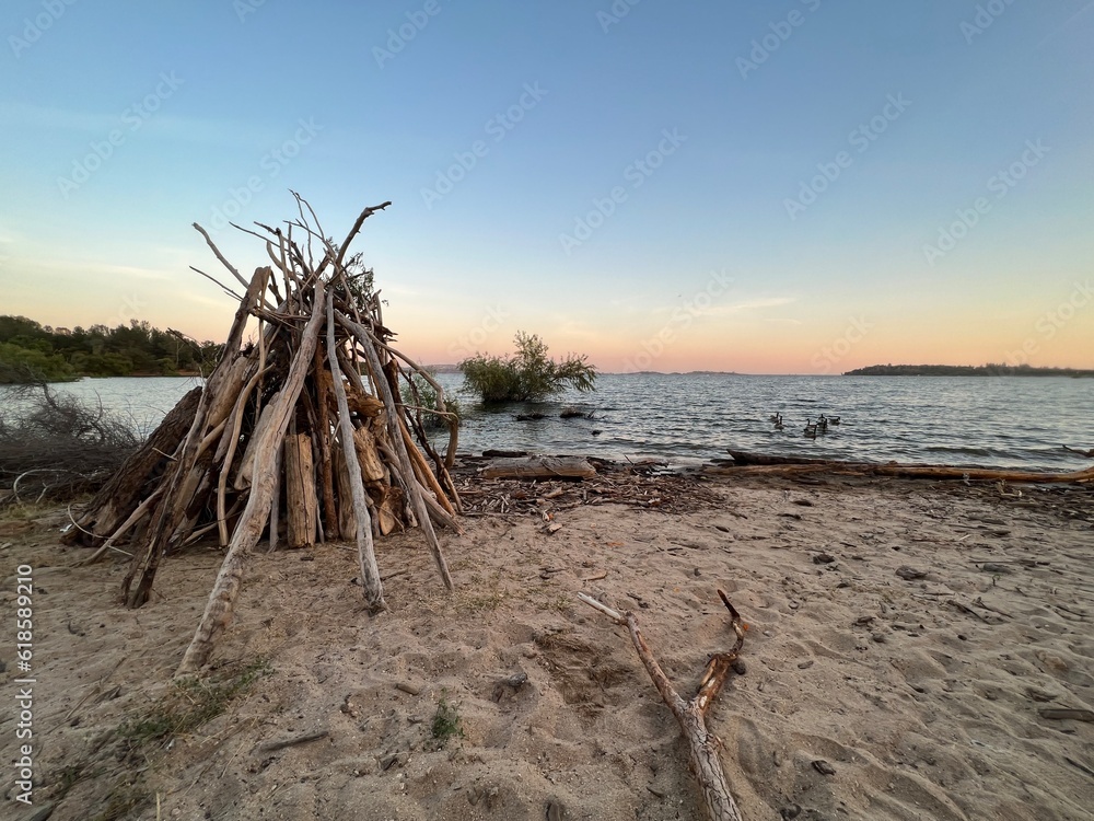Fototapeta premium driftwood teepee on beach