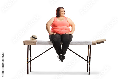 Overweight woman sitting on a bed for physical therapy