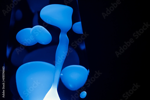 Close Up blue Lava Lamp, black background, horizontal format with copy space