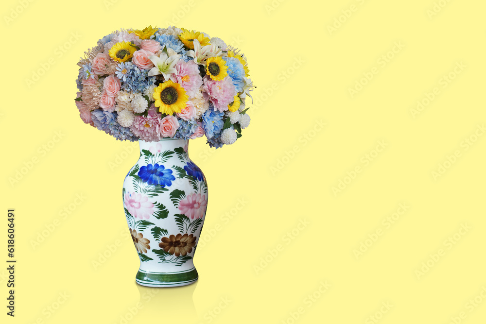 front view beautiful flowers bouquet in white and green ceramic vase on yellow background, decor, nature, gift, copy space
