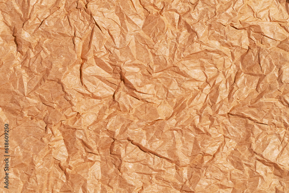 Crumpled blank sheet of brown wrapping kraft paper, vintage texture for the designer. Background of crumpled blank sheet Crumpled blank sheet of brown wrapping kraft paper, vintage texture for the designer. Background of crumpled blank sheet