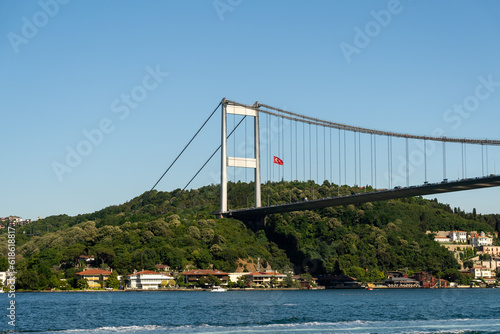 Fatih Sultan Mehmet Bridge and Turkish Flag on the Bosphorus. Istanbul, Turkey. (Fatih Korosu, Fatih Sultan Mehmet Köprüsü) photo