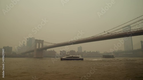 Boat Crossing Under Brooklyn Bridge with Smoke from Wildfires