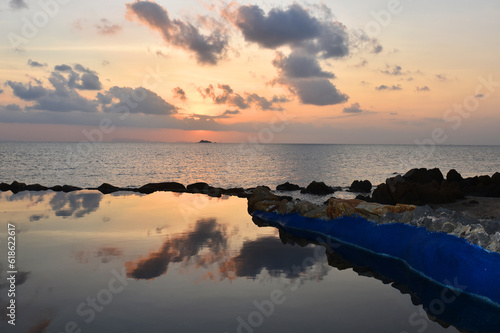 Pink sunset on the ocean. cloud. Reflection of clouds in water © Olga Rasskazova