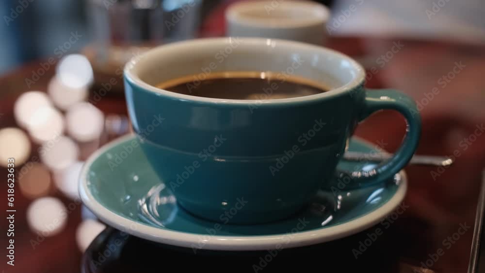 A cup of invigorating freshly brewed coffee on the table, close-up A cup of invigorating freshly brewed coffee on the table, close-up