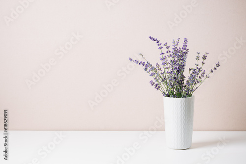 Fototapeta Bouquet of lavender in a small vase, minimal still life.