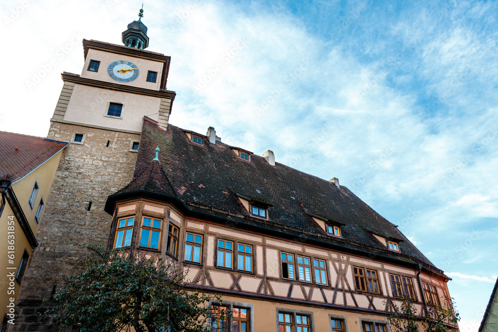 Old half timbered building and stone clock tower in the old city of Rothenburg ob der Tauber, Bavaria, Germany, Europe