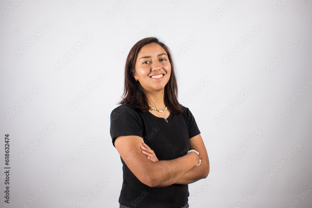 Obraz premium Portrait of smiling latina woman on light background. Concept of people and portraits.