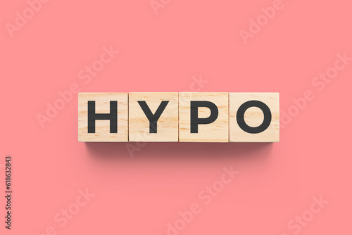 HYPO (Hypothyroidism) wooden cubes on red background photo