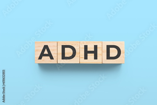 ADHD (Attention Deficit Hyperactivity Disorder) wooden cubes on blue background