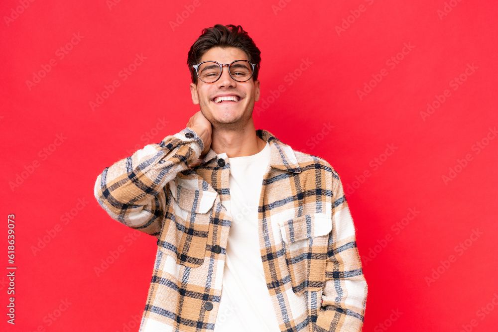 Young caucasian handsome man isolated on red background laughing Young caucasian handsome man isolated on red background laughing