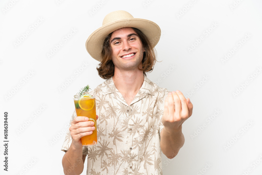 Young handsome man holding a cocktail isolated on white background inviting to come with hand. Happy that you came Young handsome man holding a cocktail isolated on white background inviting to come with hand. Happy that you came