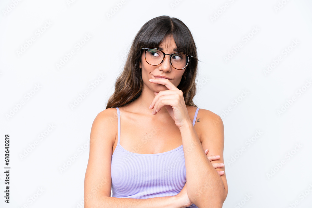 Young caucasian woman over isolated background With glasses and having doubts Young caucasian woman over isolated background With glasses and having doubts