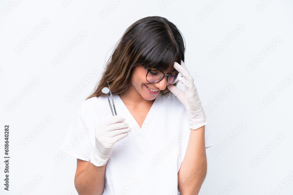 Dentist caucasian woman holding tools isolated on white background laughing Dentist caucasian woman holding tools isolated on white background laughing