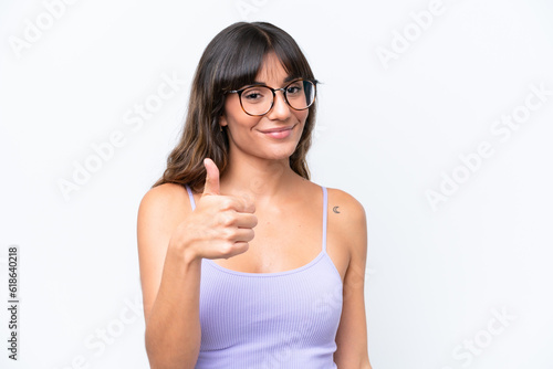 Young caucasian woman over isolated background With glasses and with thumb up