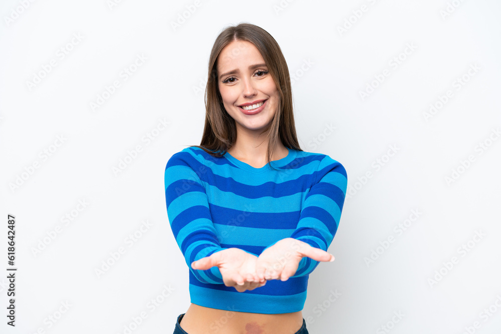 Young pretty caucasian woman isolated on white background holding copyspace imaginary on the palm to insert an ad Young pretty caucasian woman isolated on white background holding copyspace imaginary on the palm to insert an ad