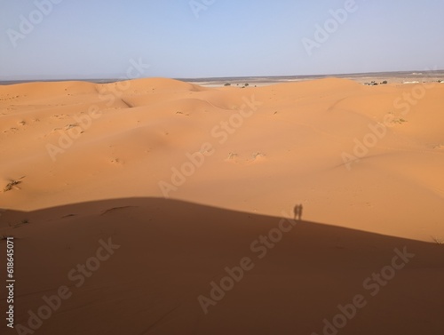 A shadow ot two people on the Great Dune of Merzouga in the Erg Chebbi desert in the African Sahara  Morocco