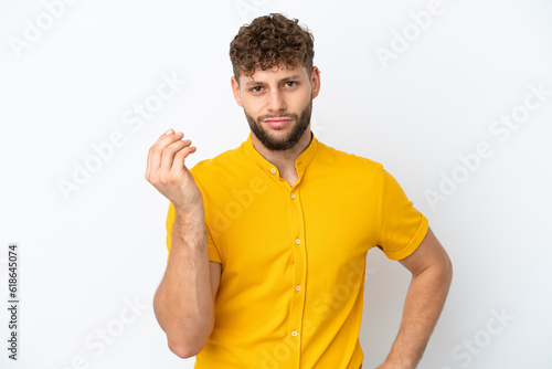 Young handsome caucasian man isolated on white background making Italian gesture