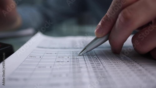 Hand makes notes on a paper notebook, close-up