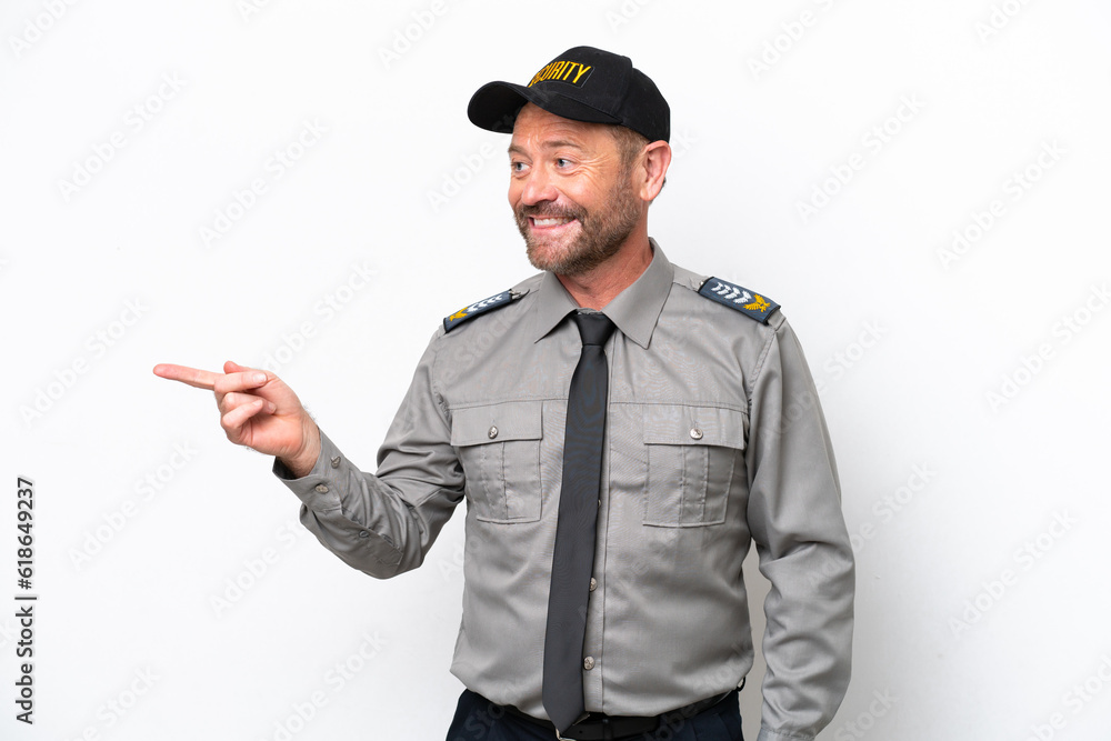 Middle age security man isolated on white background pointing finger to the side and presenting a product Middle age security man isolated on white background pointing finger to the side and presenting a product