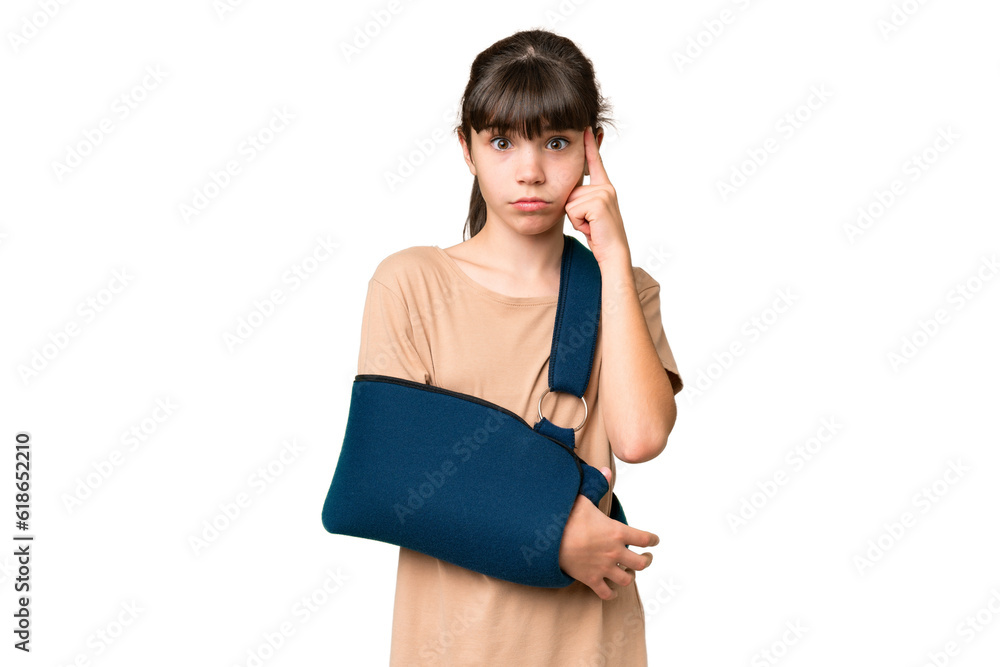 Little caucasian girl with broken arm and wearing a sling over isolated background thinking an idea Little caucasian girl with broken arm and wearing a sling over isolated background thinking an idea
