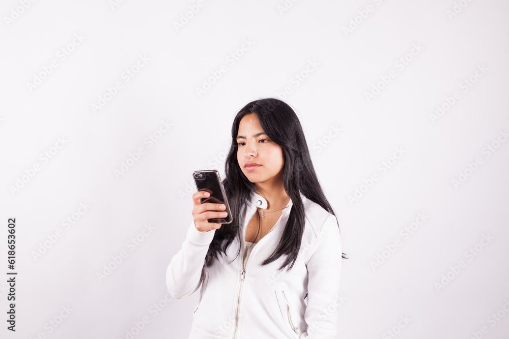 photograph of latina woman in studio with cell phone in hand. Concept of people and technology. photograph of latina woman in studio with cell phone in hand. Concept of people and technology.