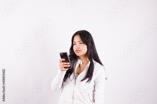 photograph of latina woman in studio with cell phone in hand. Concept of people and technology.