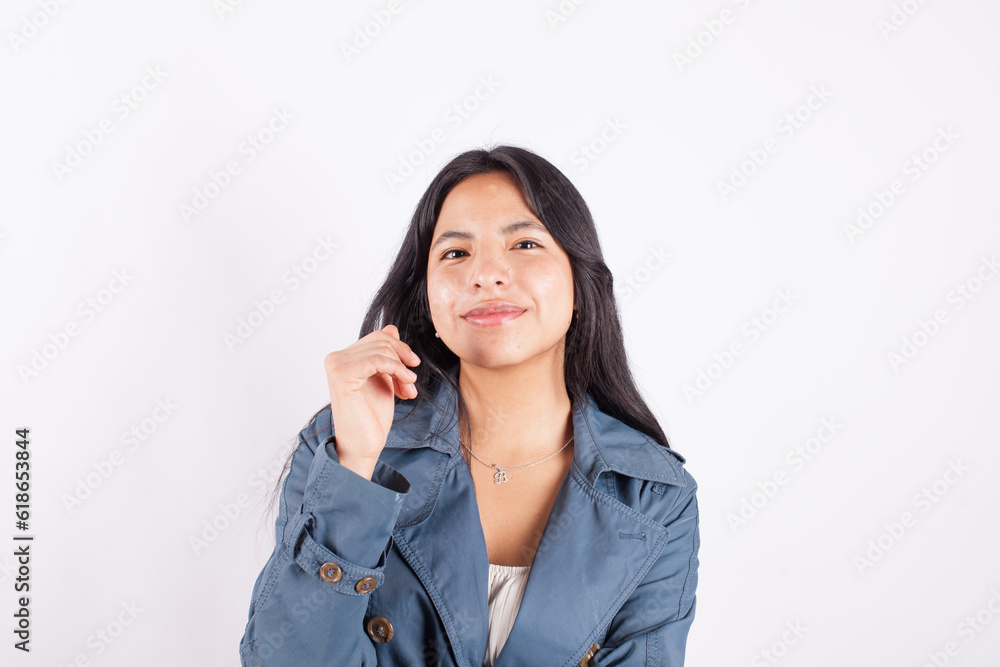 Portrait of young attractive hispan woman on a light background of photographic studio. Concept of people. Portrait of young attractive hispan woman on a light background of photographic studio. Concept of people.
