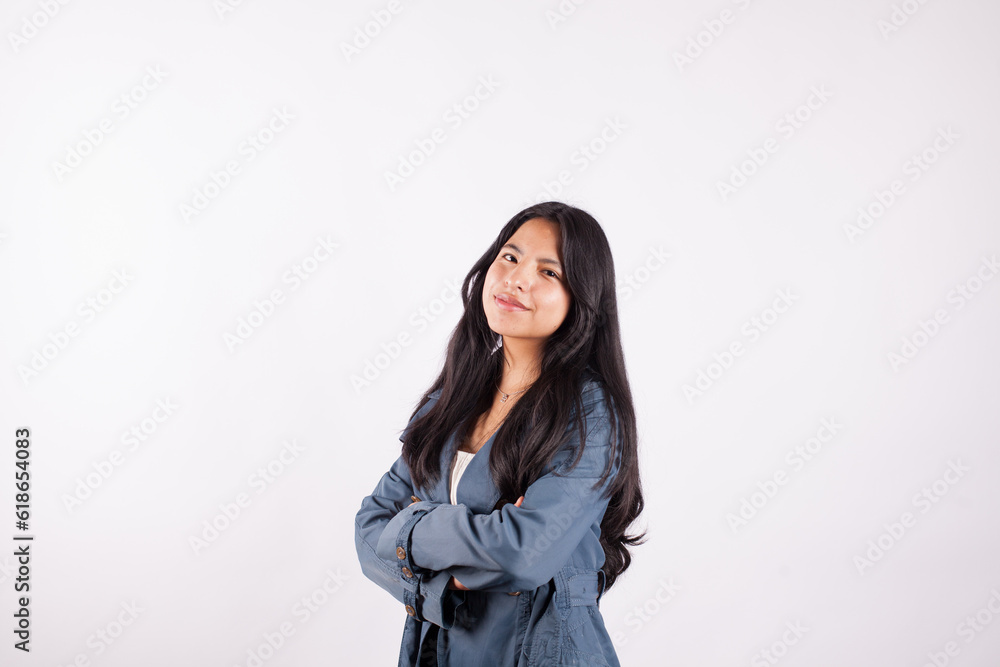 Portrait of young latina woman with crossed arms on light background of photo studio. Concept of people. Portrait of young latina woman with crossed arms on light background of photo studio. Concept of people.