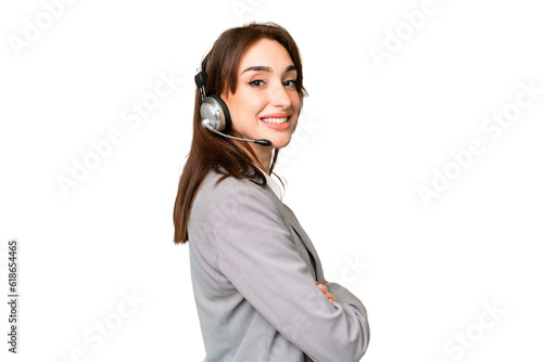 Telemarketer caucasian woman working with a headset over isolated chroma key background with arms crossed and looking forward