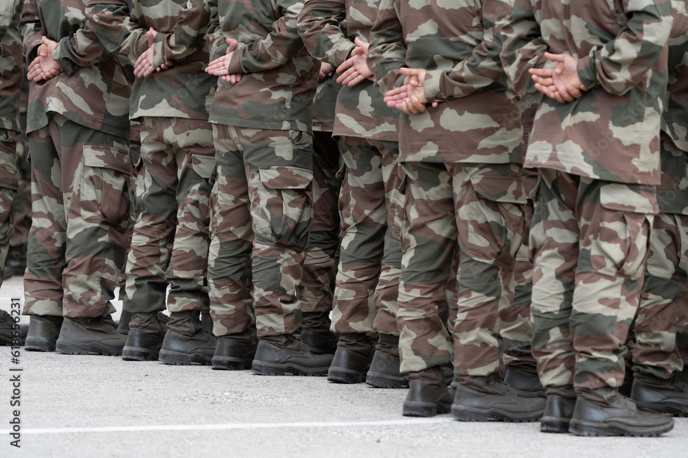 Soldiers in a relaxed position during the ceremony. Military camouflage outfit. Soldiers in a relaxed position during the ceremony. Military camouflage outfit.