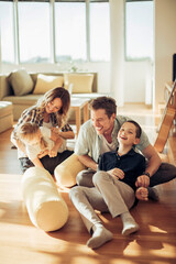 Young family playing in the living at home