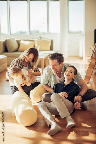 Young family playing in the living at home photo